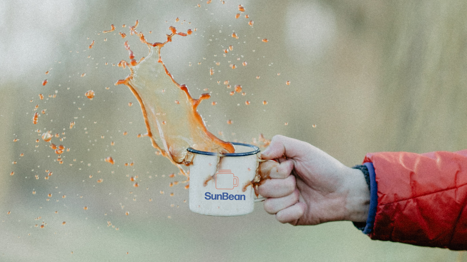 Hand holding coffee mug with giant splash of coffee