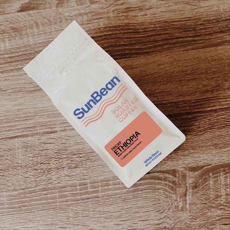 Sun Bean branded coffee bag on wood table. Decaf Ethiopia label.
